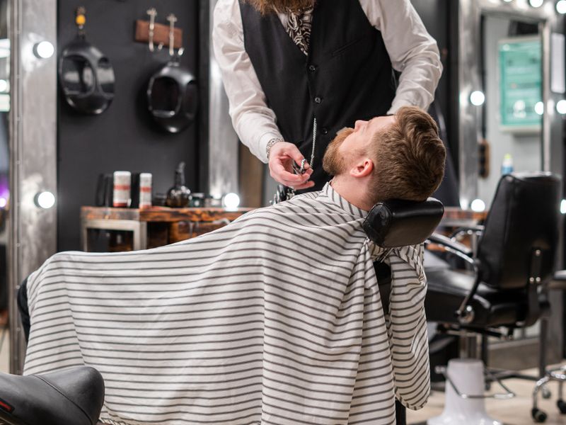 Beard Design + Hot Towel — A precision beard trim followed by a relaxing hot towel treatment.