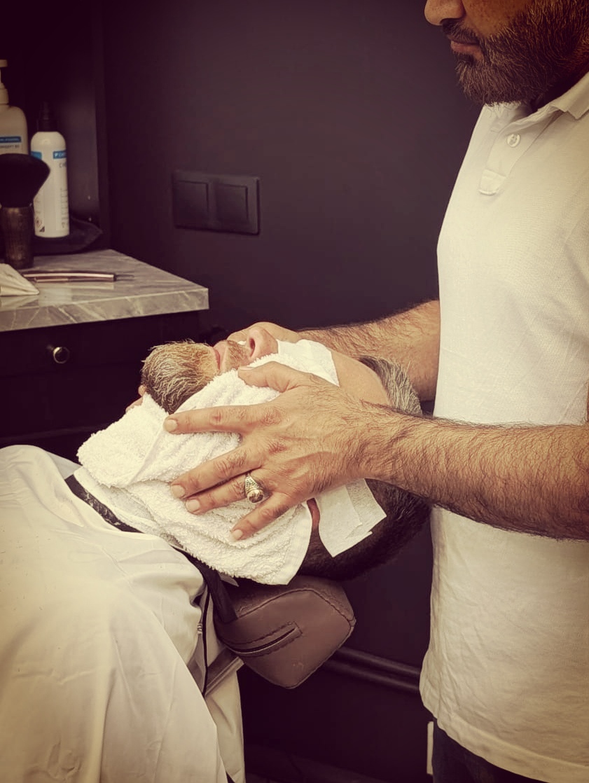 Haircut + Beard Design + Hot Towel — The complete grooming experience: haircut, beard trim, and a soothing hot towel finish.